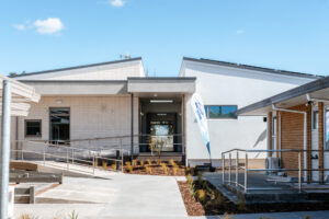 A construction site showing a building in progress. Traffic cones and a construction site sign in the foreground.
